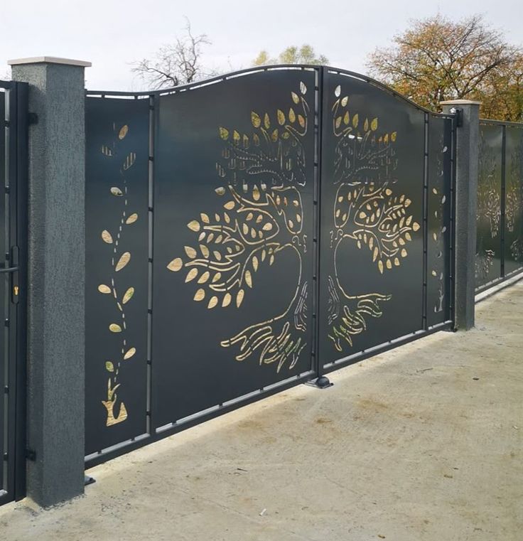 Tree-of-life laser-cut gold detail on charcoal gate